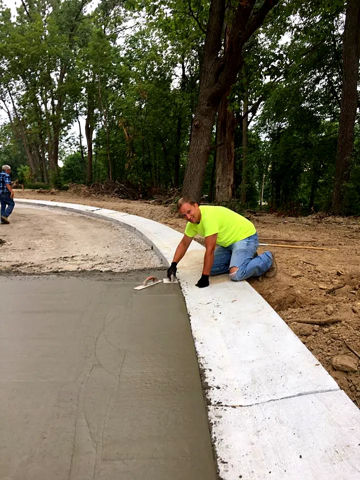 RBF crew member finishing a new concrete curb