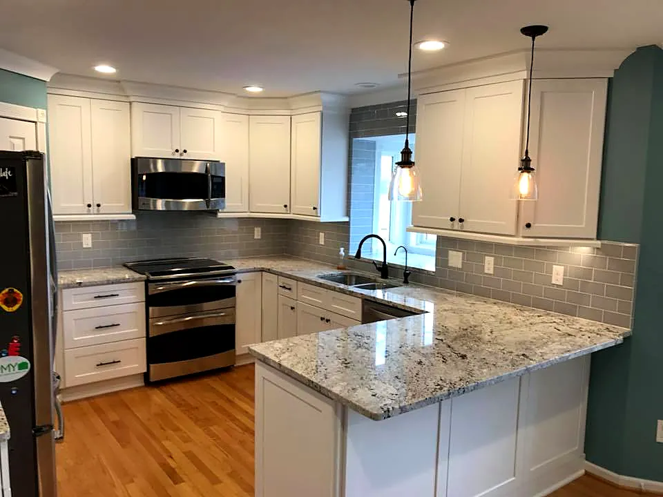 Kitchen with granite countertops, white cabinets and stainless appliances