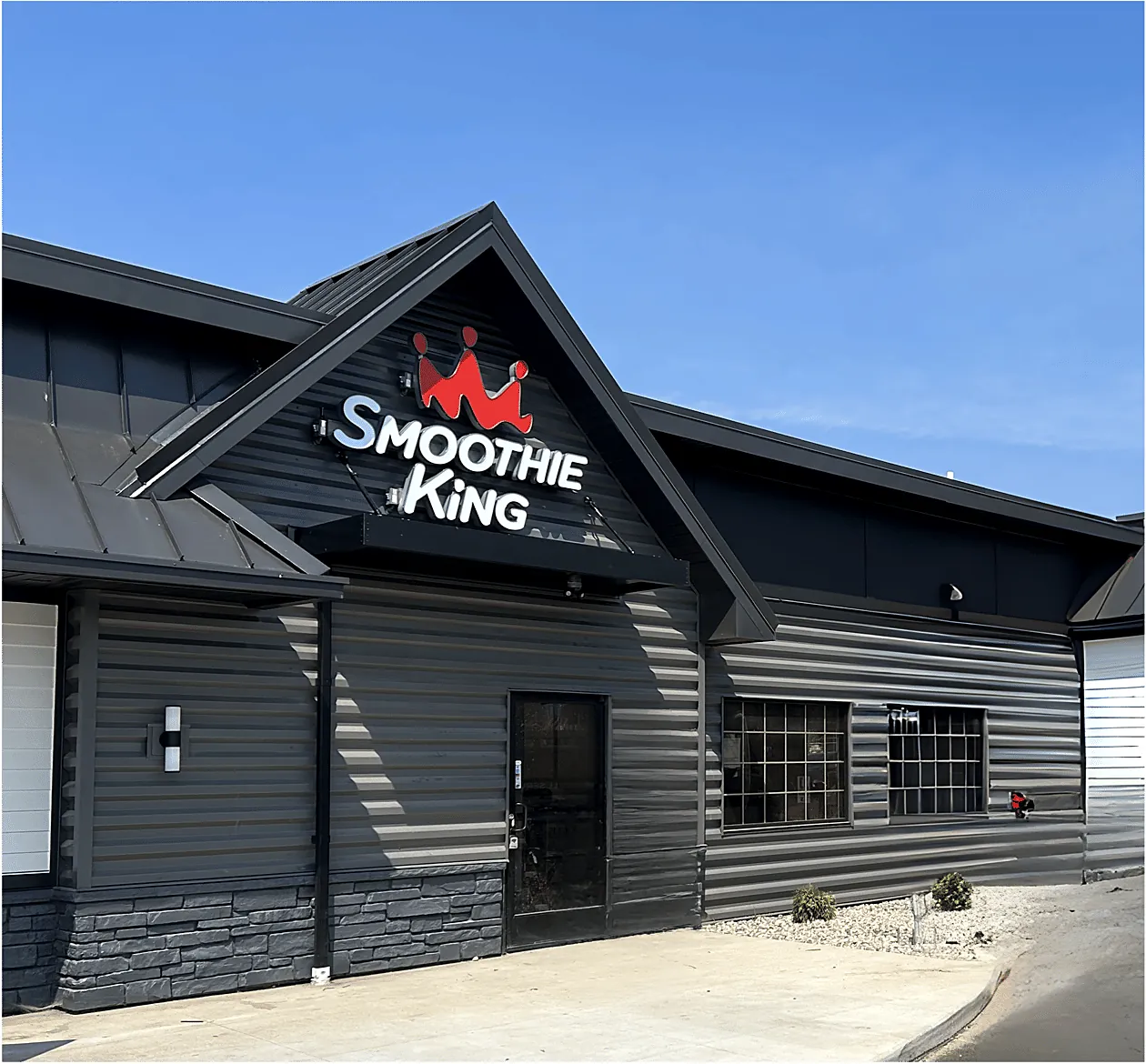 Smoothie King restaurant with dark board-and-batten siding