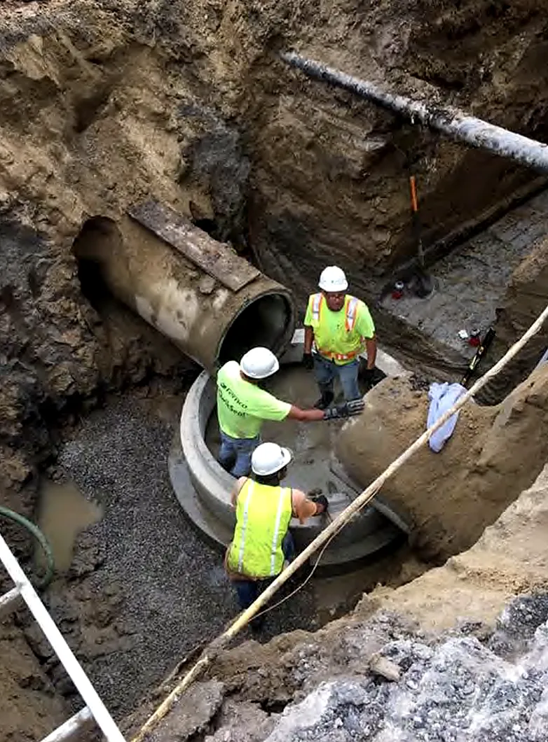 RBF crew connecting large-diameter storm sewer pipe deep in an excavation