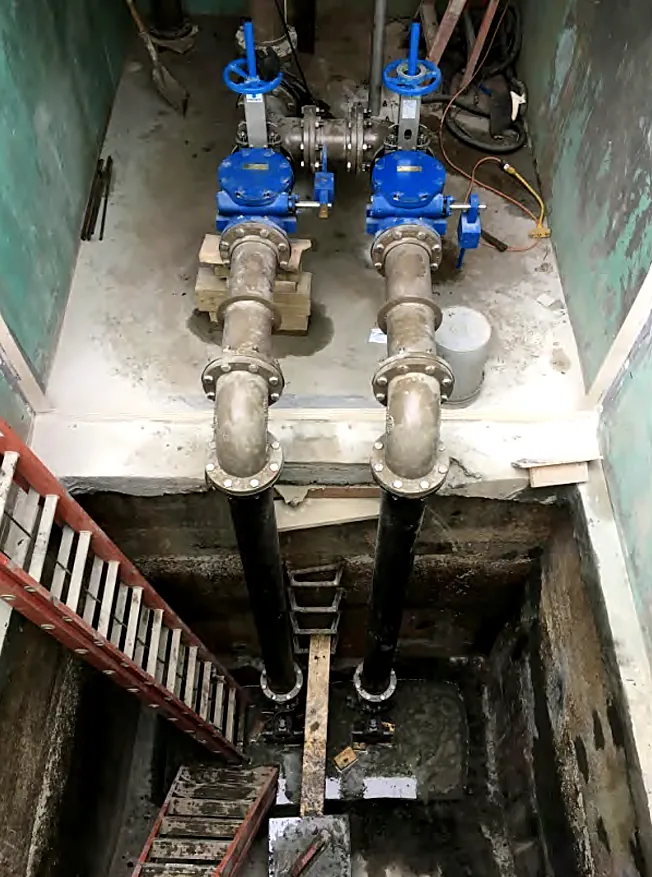 New valves and piping inside an underground valve vault