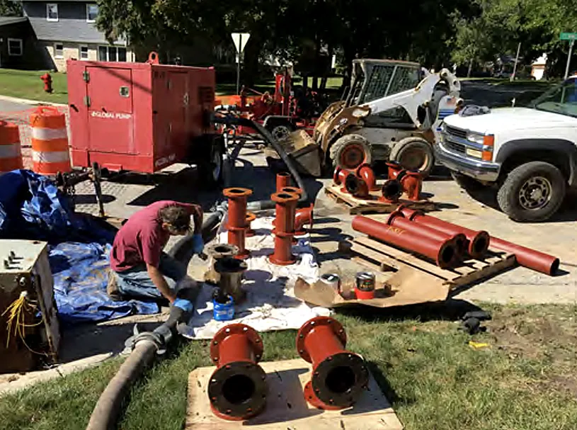 Water main fittings and pipe staged for installation